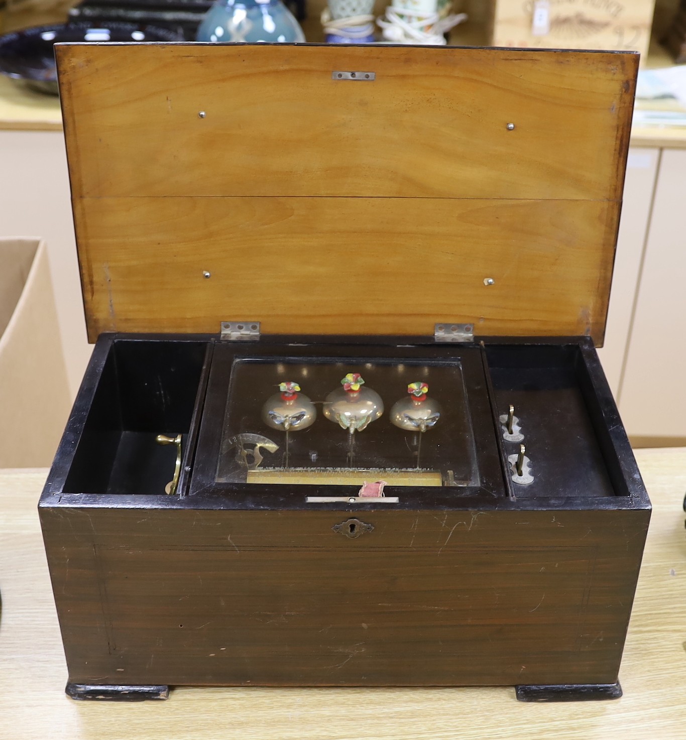 A late 19th century music box, with visible bells movement, 47cms wide, 27cm deep
